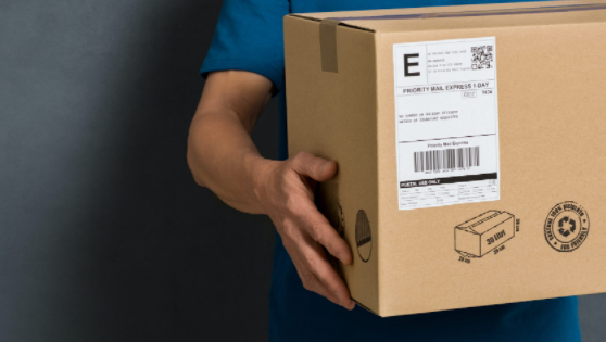 Close-up of an arm holding a parcel for delivery.