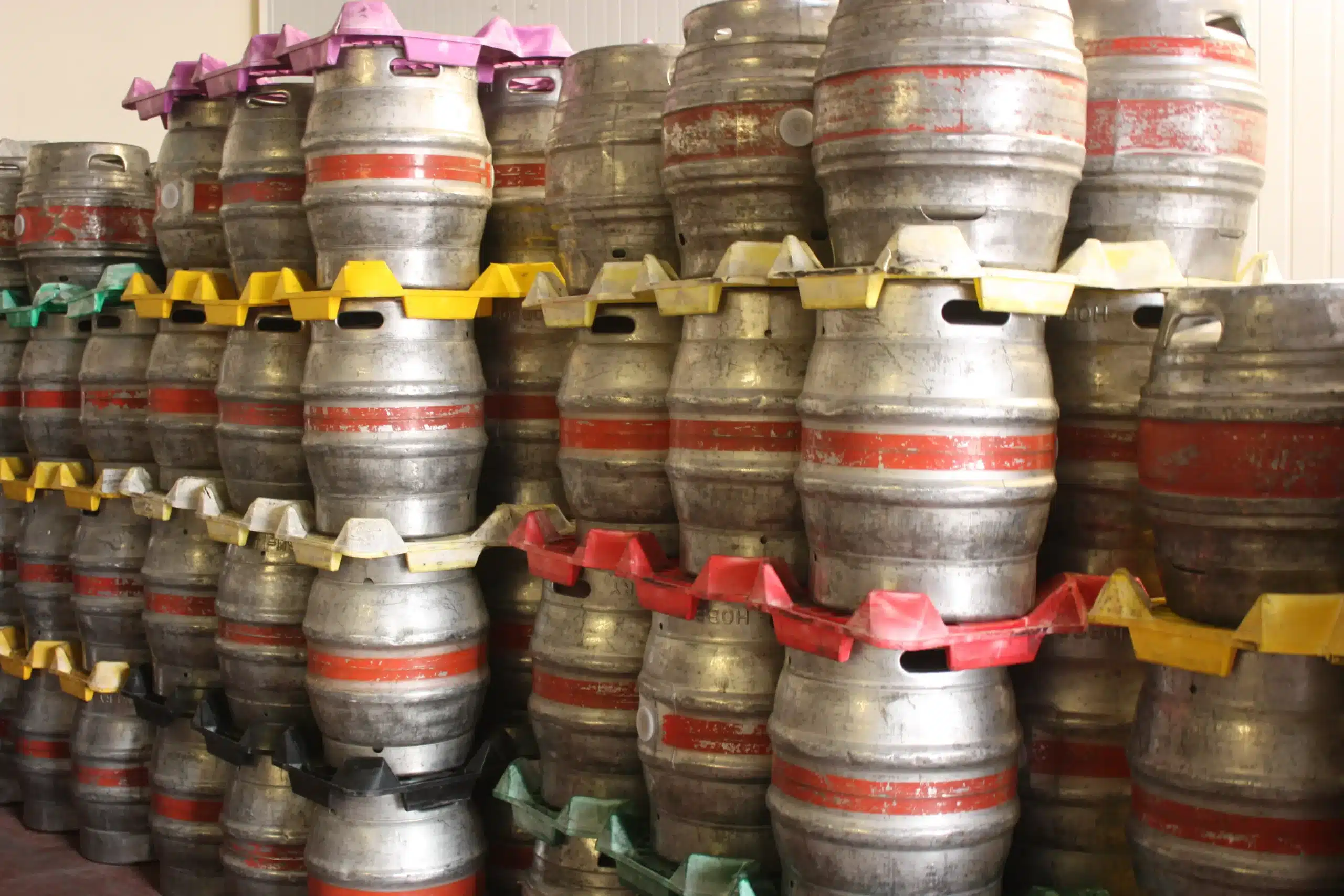 Stacked palettes of beer kegs