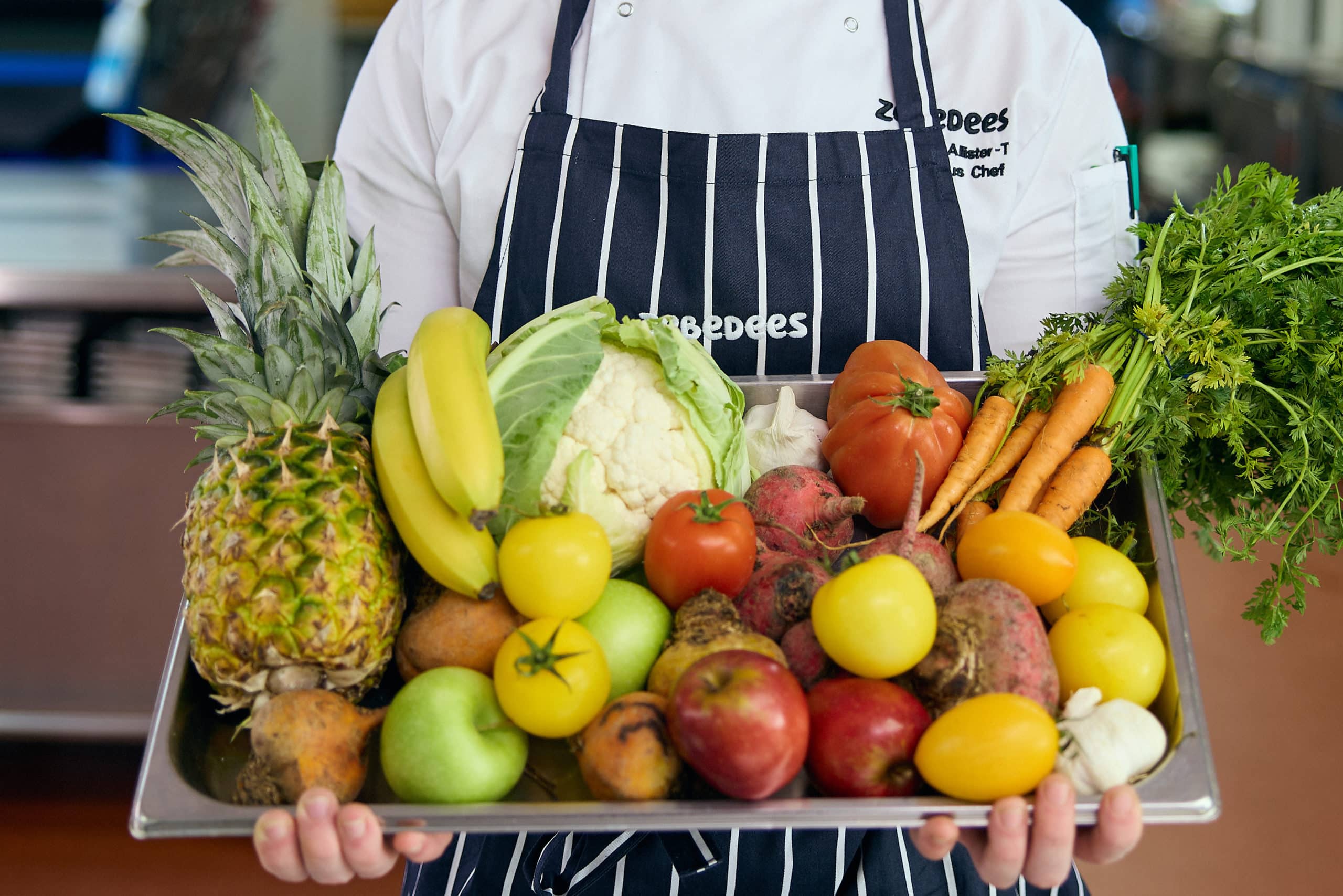 Image of fresh fruit and vegetables being held by a Zebedees team member