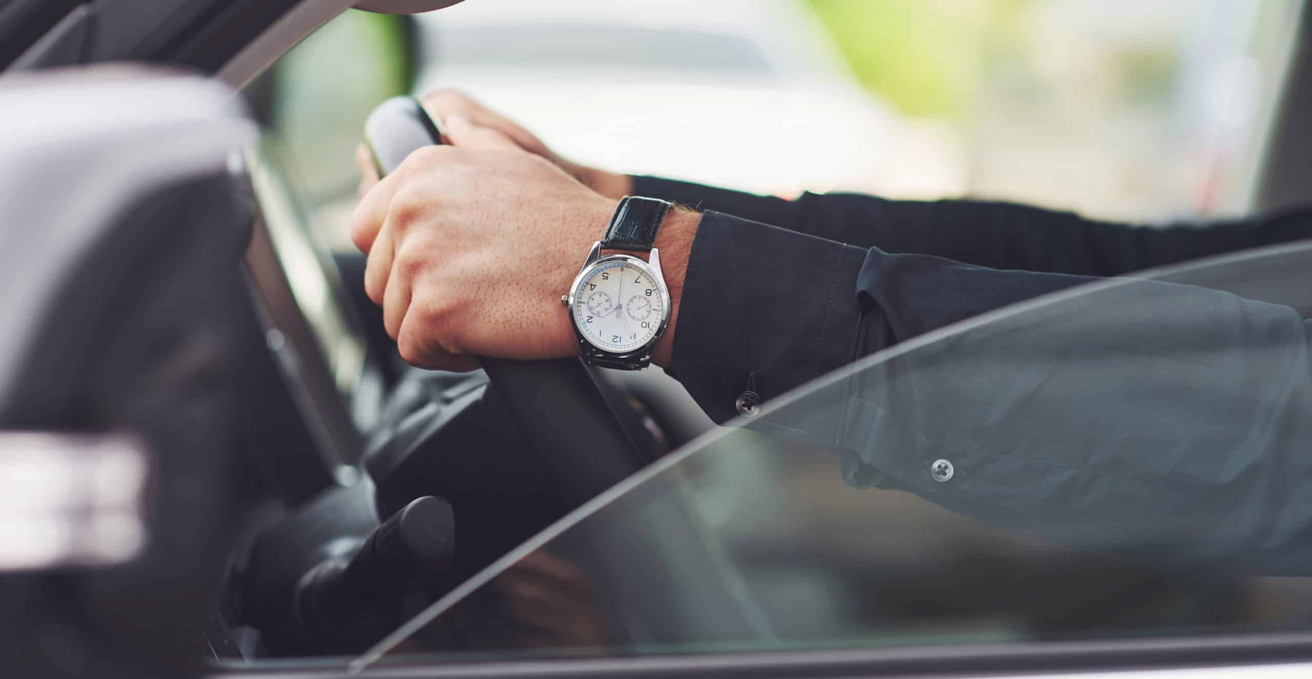 Image of person driving a vehicle showing his watch