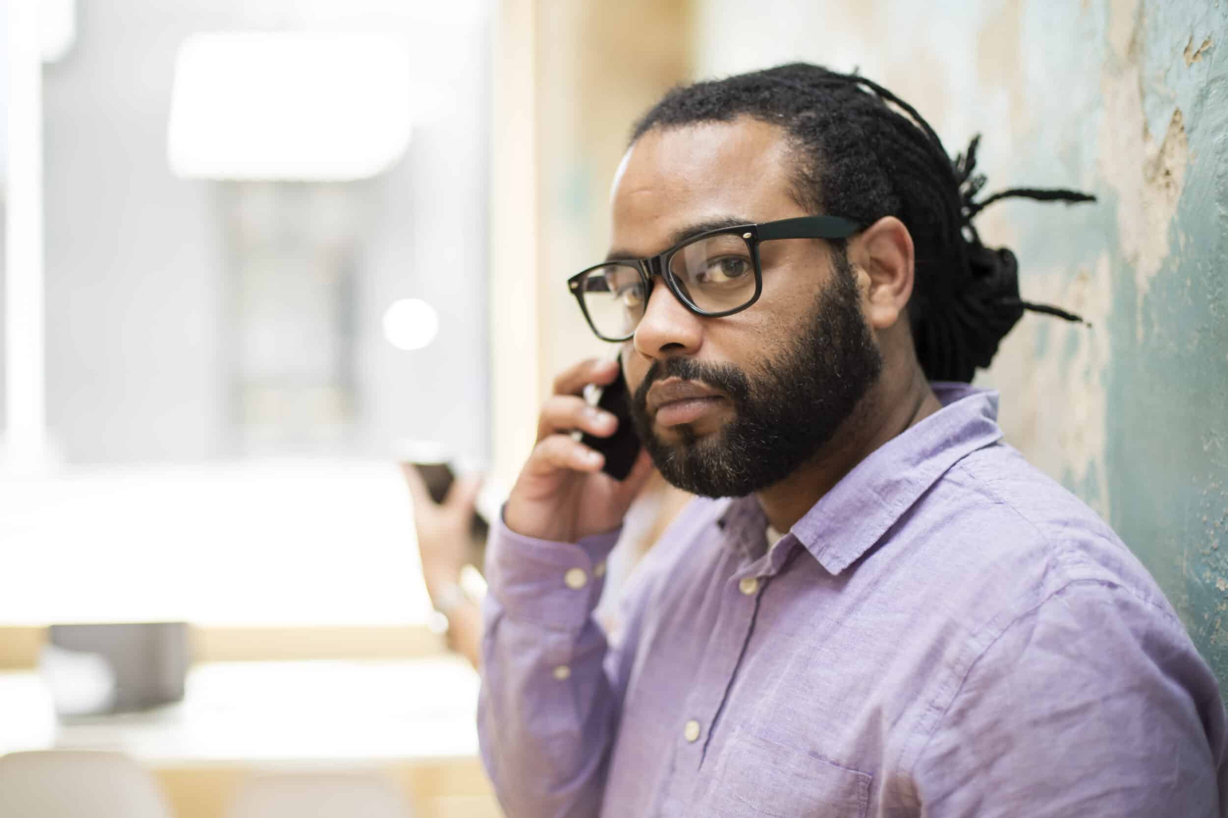 Customer on his mobile phone looking unhappy due to his delivery being late