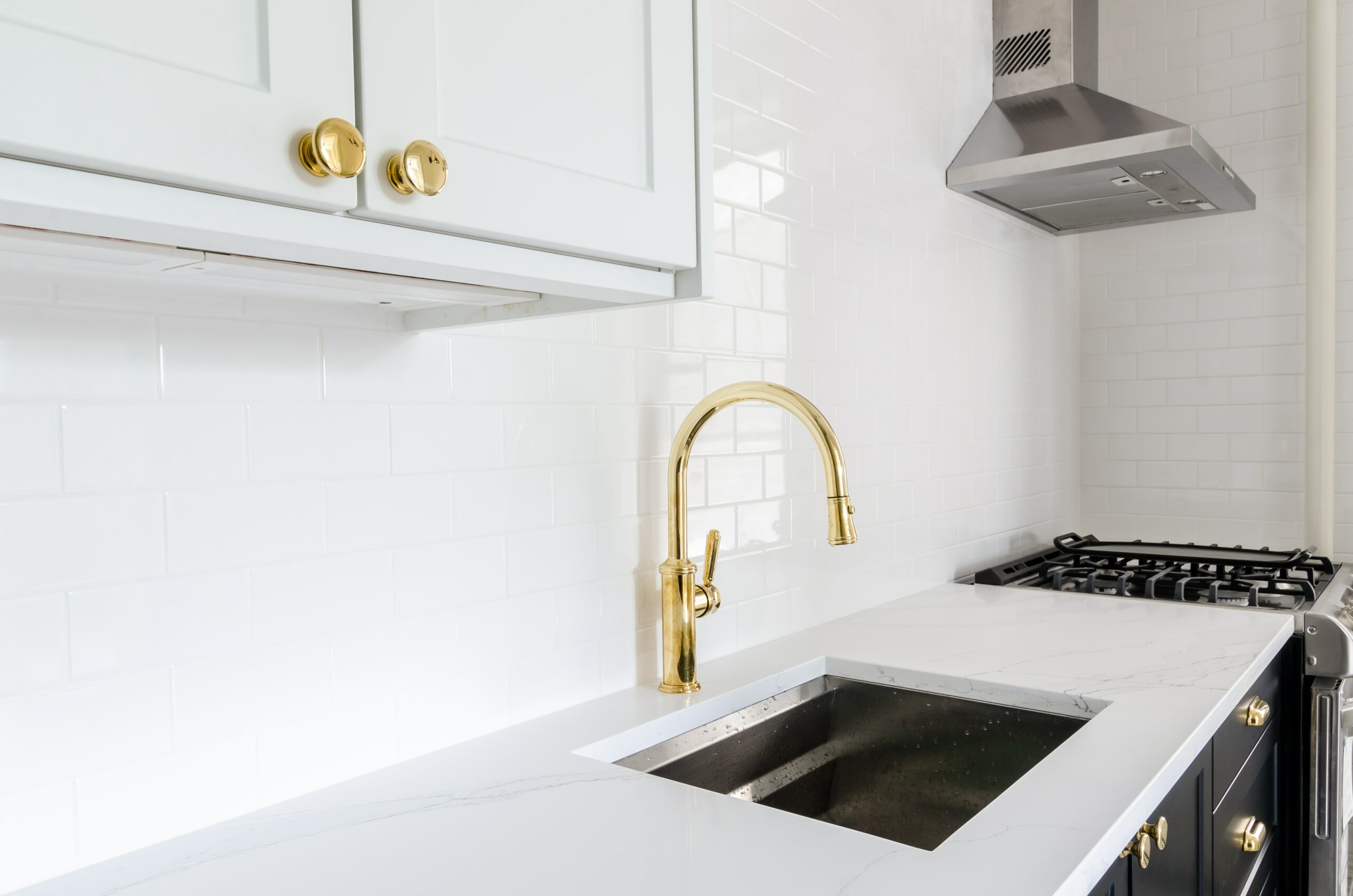 Modern SwiftUK kitchen with white worktop and gold taps