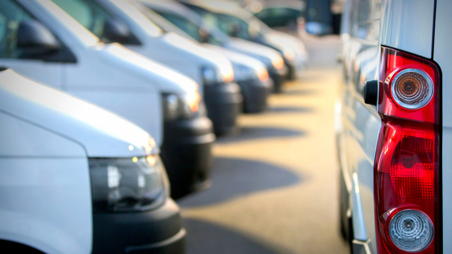 row of parked white vans