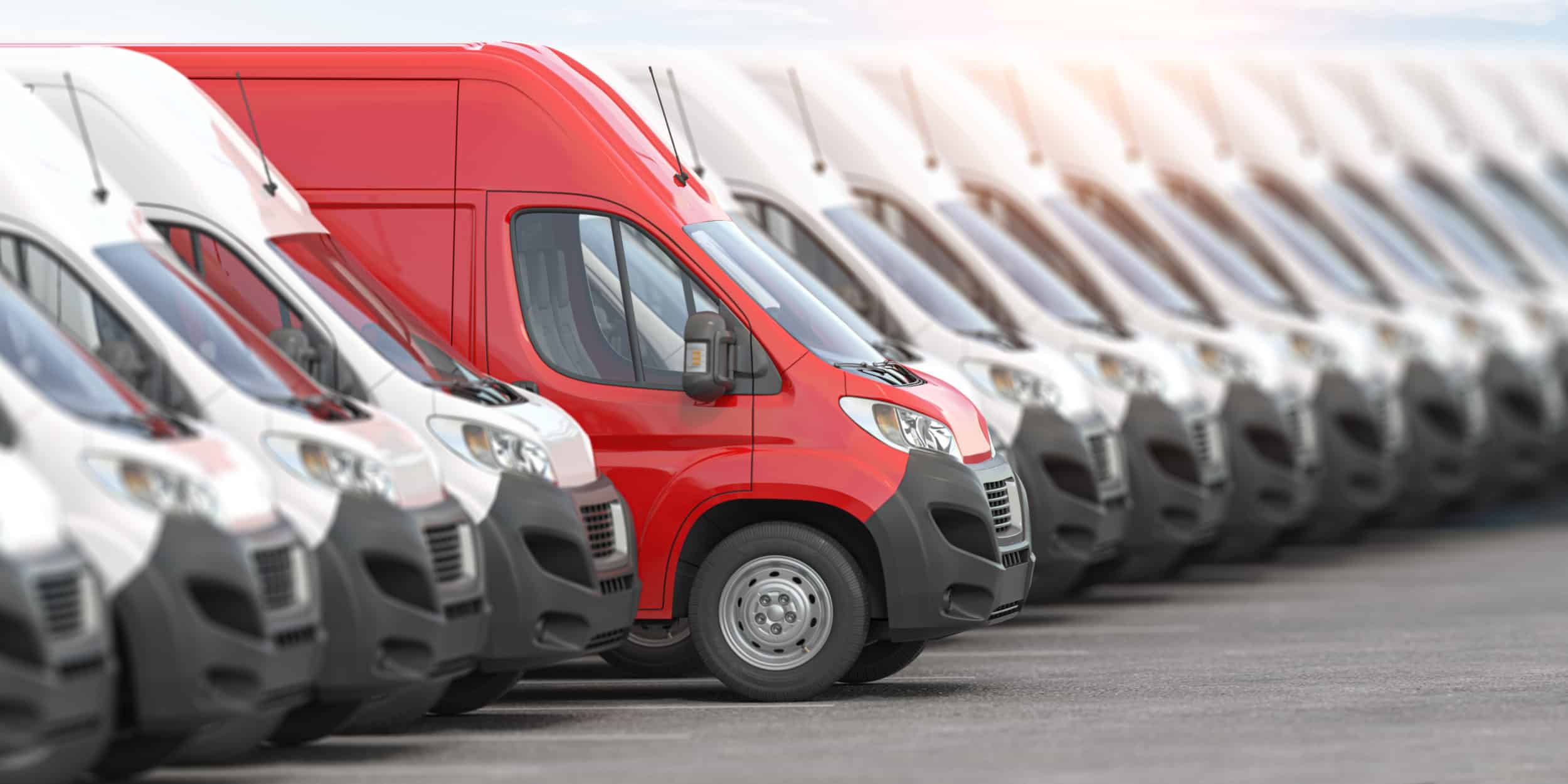 White vans lined up, with a prominent red van in the middle