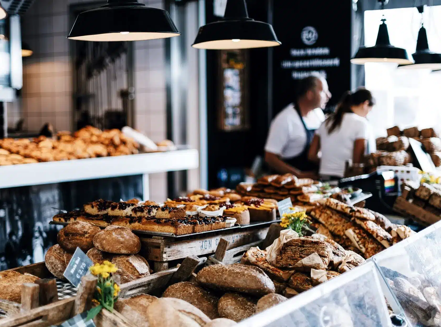 a bakery with a counter covered in bread and pastries