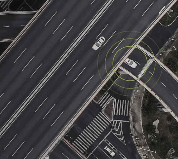 An aerial shot of a road, with one car circled in concentric yellow lines