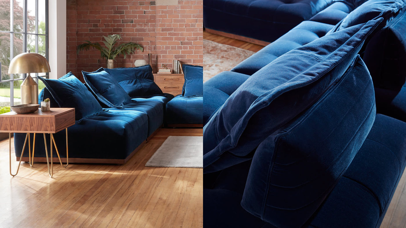 Blue, velvet sofology sofa in a living room
