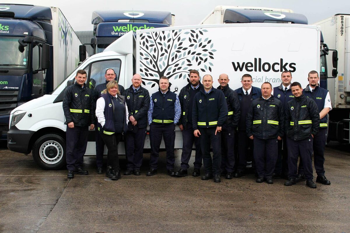 Wellocks delivery drivers smiling and standing infront of Wellocks van